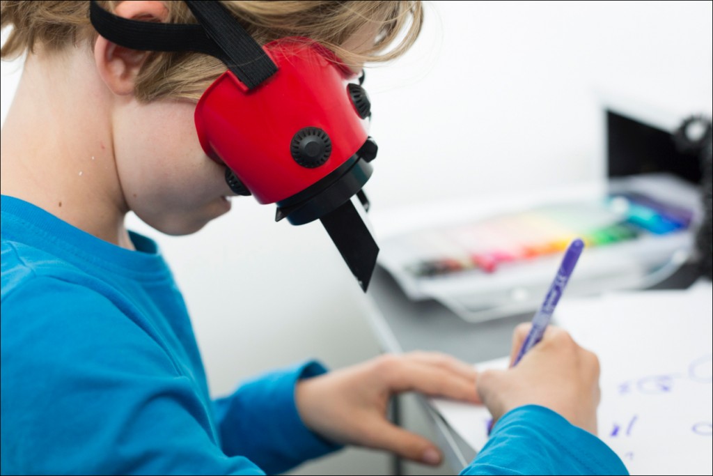 life CU boy drawing w red glasses